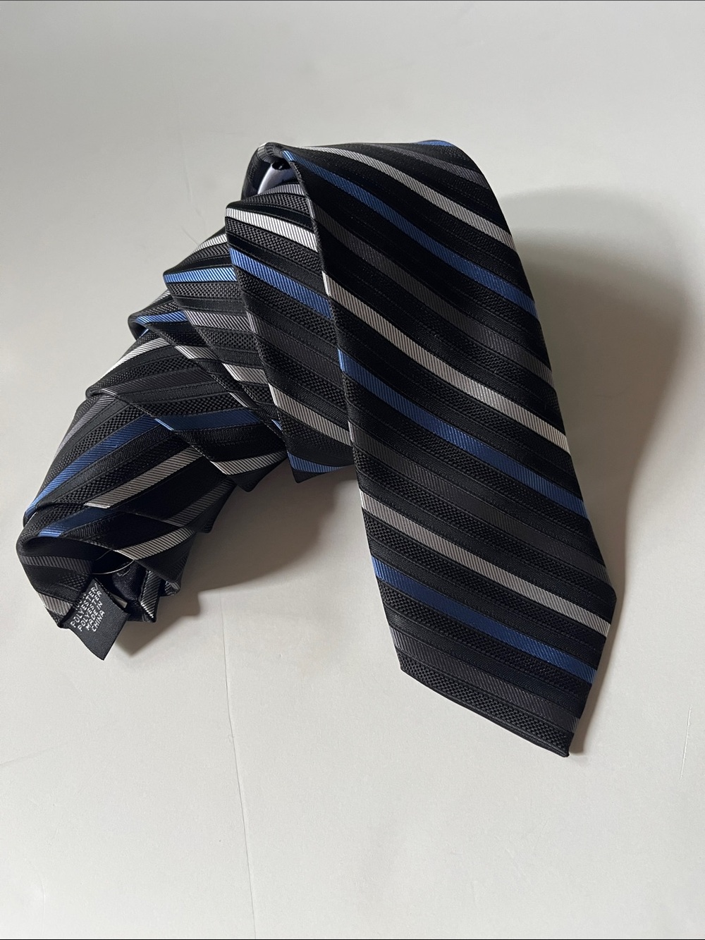 Calvin Klein, black, blue, grey and white striped tie.
